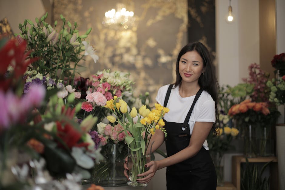Florist in shop arranging vibrant flower bouquet with various blooms and colors. Perfect for decoration ideas.