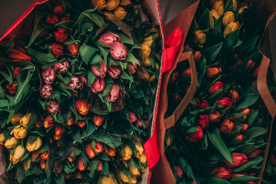Vibrant tulip bouquets displayed in paper bags, showcasing bright spring colors.